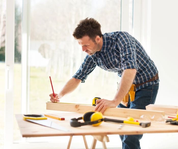 A man is working on something at the table.